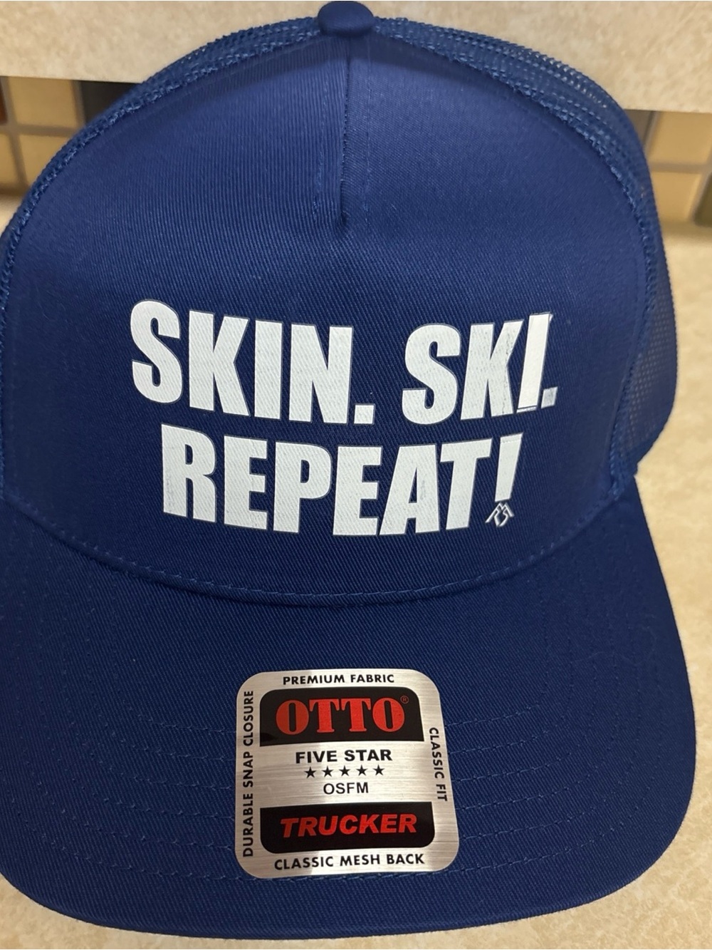 OTTO Blue Trucker Hat with White 'SKIN. SKI. REPEAT!' Text